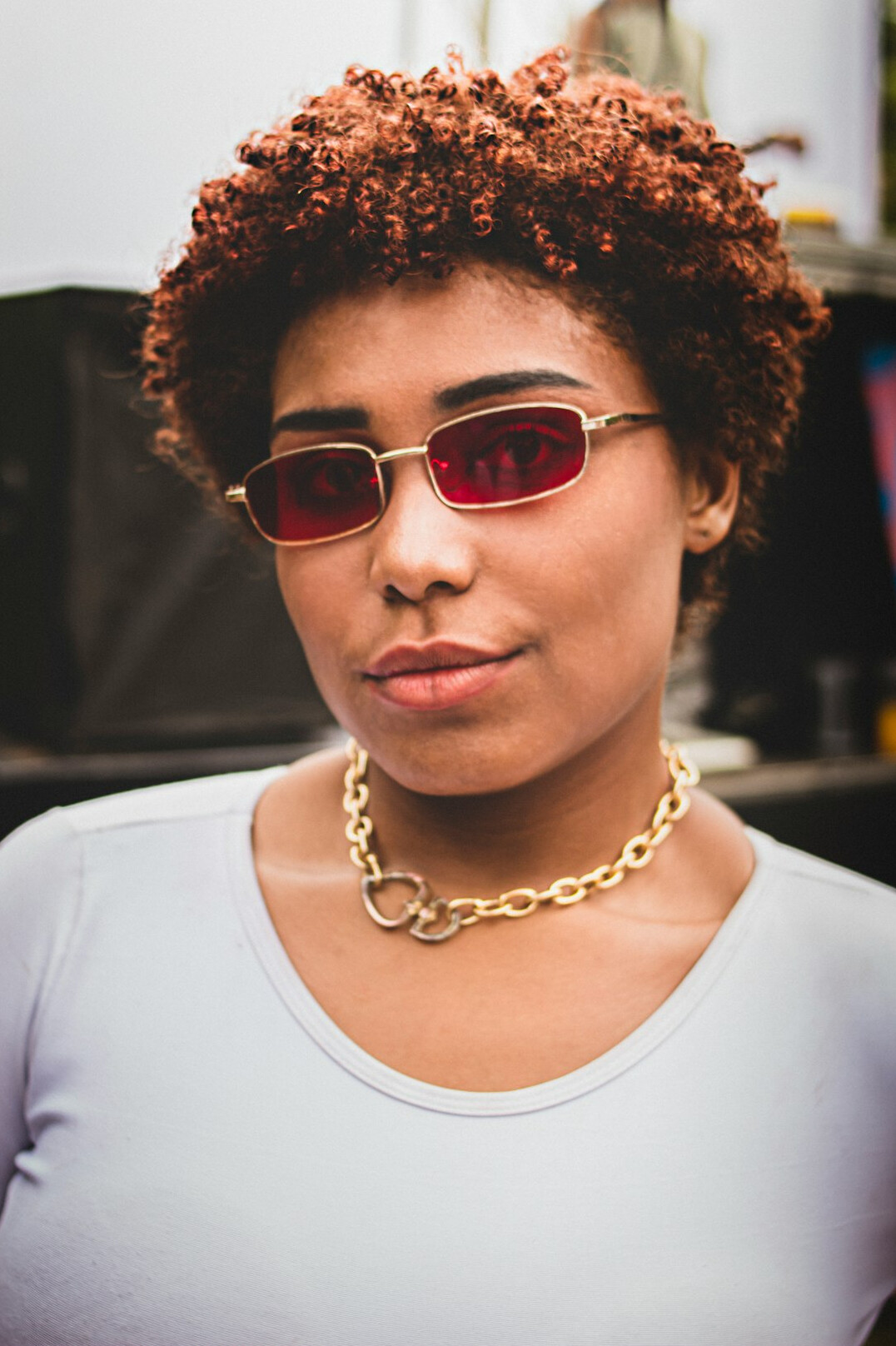 Studio portrait of a Brazilian woman with short hair and glasses