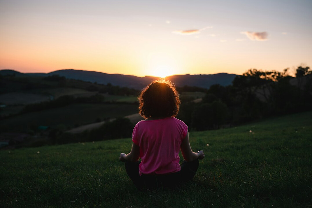 person meditating alone