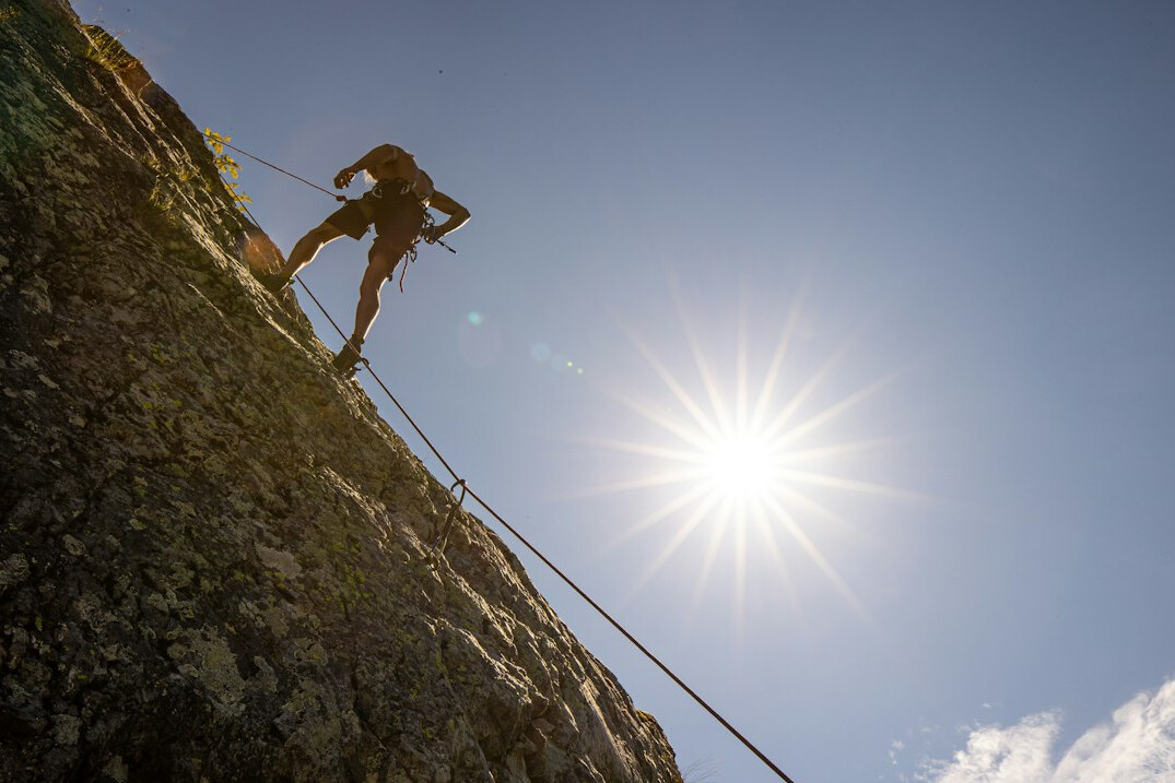 person climbing mountain